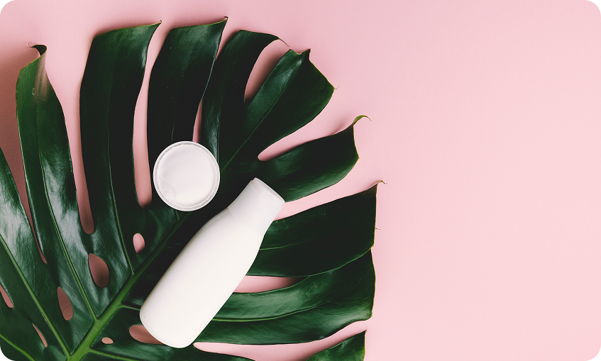 top-view-tropical-leaves-with-beauty-tools-cosmetics